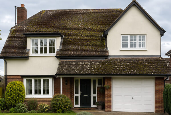 Luton house roof before cleaning with moss affecting kerb appeal