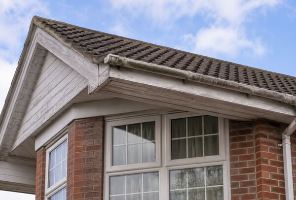 Roofline in Oxford before painting, with tired fascias, soffits and guttering