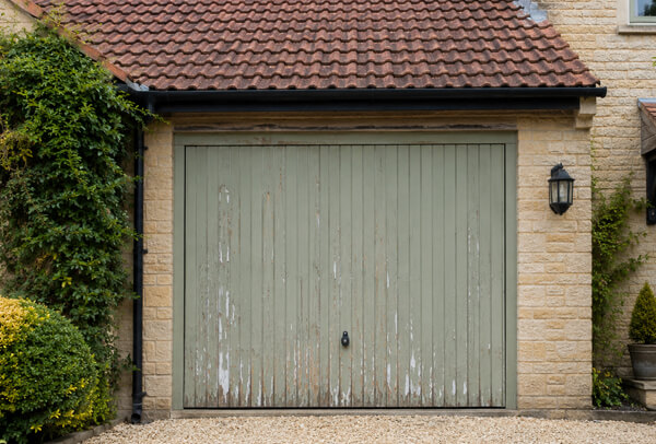 Garage door before repainting in Oxford, showing a tired exterior finish