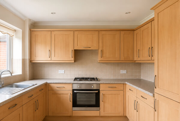 Kitchen cupboards in Northampton before aftercare advice, showing an older finish