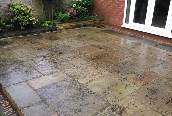 Patio in Bedford before deep cleaning with dirt and organic staining