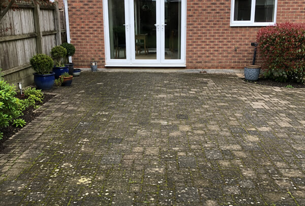 Block paving patio in Bedford before pressure washing and re-sanding