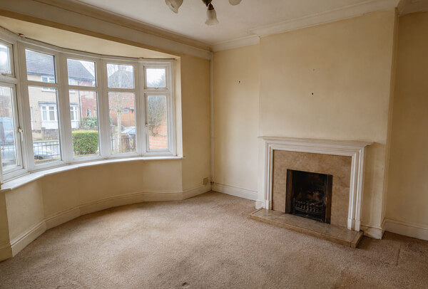 Room in Bedford before painting with tired walls and an old colour scheme