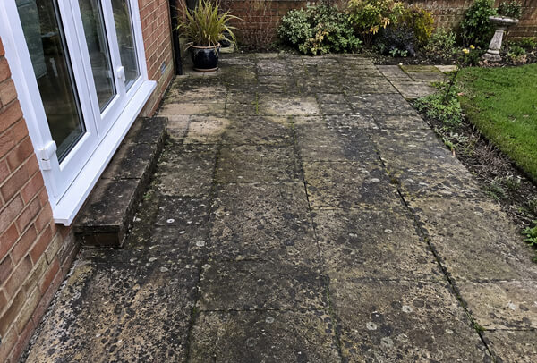Patio in Bedford before cleaning with dark marks and weather staining