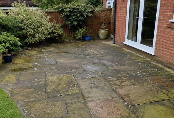 Sandstone patio in Bedford before cleaning with weather staining