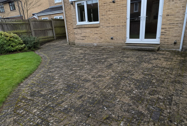 Patio in Luton before cleaning with dark marks and weather staining
