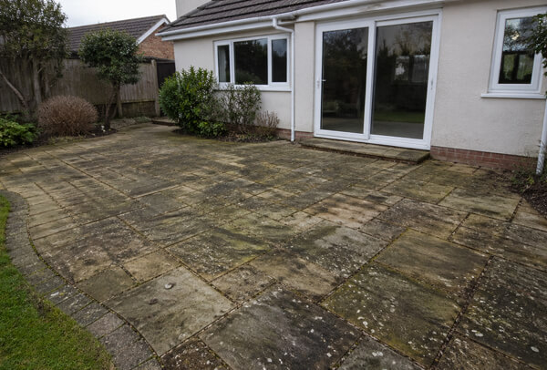Sandstone patio in Luton before cleaning with weather staining