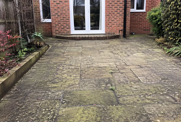 Patio surfaces in Northampton before cleaning, including stone and paving with heavy weathering