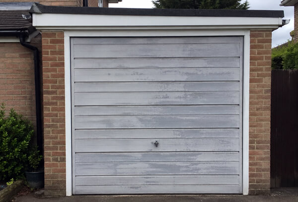 Steel garage door in Luton before repainting, with a dull weathered surface