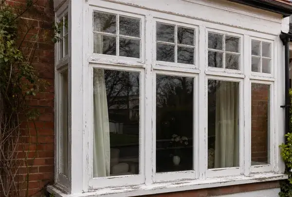 Timber window frame in Luton before painting with weathered woodwork and tired old paint