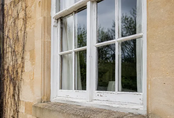 Timber window frame before painting with tired old paint