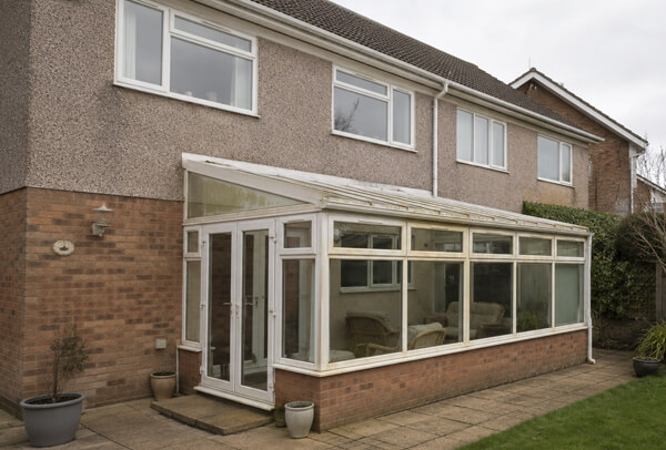 uPVC conservatory before painting with old white frames