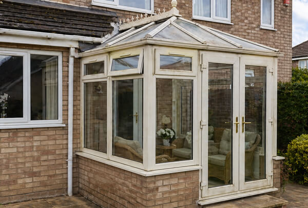 White uPVC conservatory in Luton before spraying with frames that look aged and dull