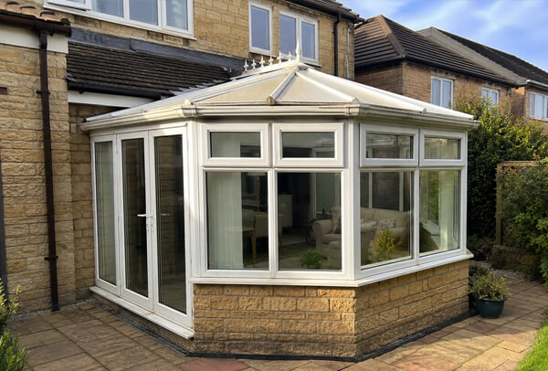 uPVC conservatory before painting with tired white frames
