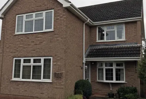 uPVC window frames in Northampton before painting, with faded white surfaces