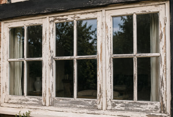 Weathered timber window frames before repainting in Aylesbury