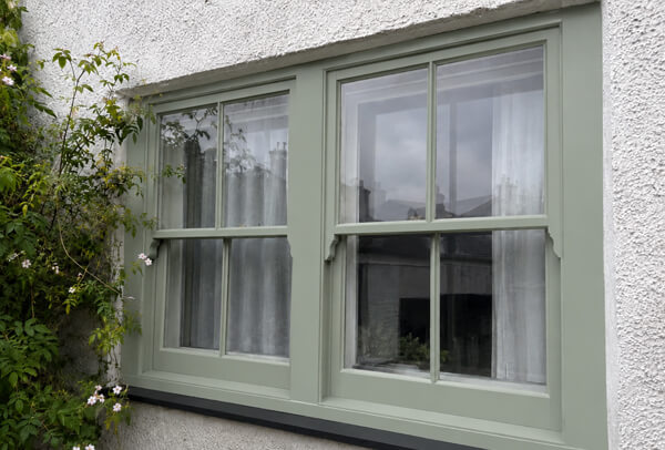 Window frames after suitable preparation and painting in Dunstable