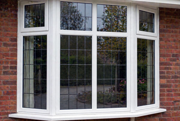 Exterior window frames in Northampton before painting, showing faded and tired surfaces