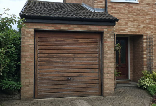 Timber garage door in Luton before repainting, showing weathered paintwork