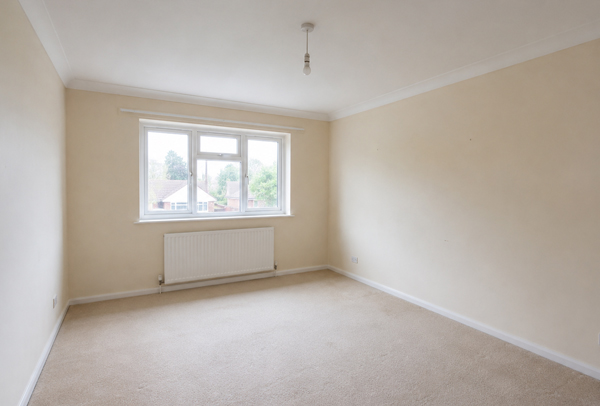 Lived in room in Dunstable before painter and decorator work with tired colours and dull woodwork