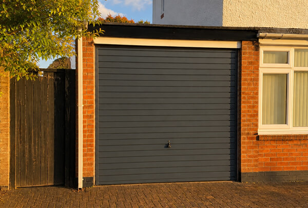 Weathered garage door after repainting in Watford