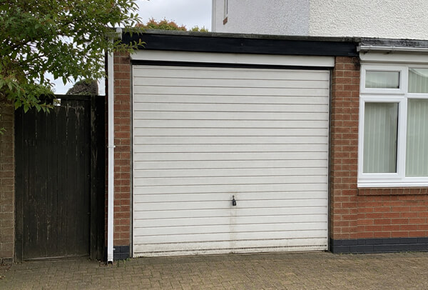 Weathered garage door before painting in Watford