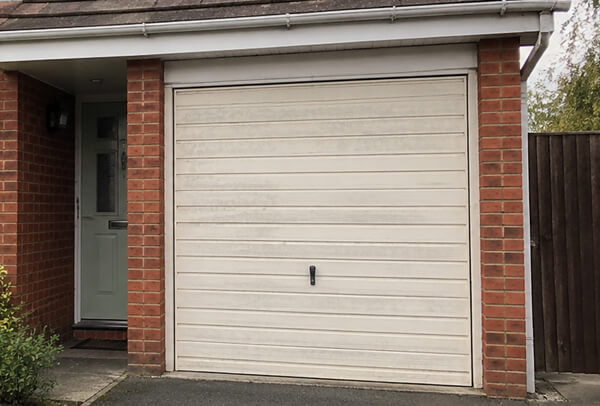 Side hinged garage doors before painting in Watford