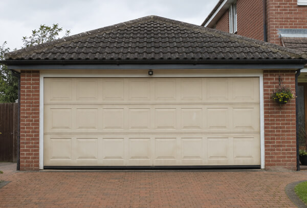 Weather faded garage door before repainting in Watford