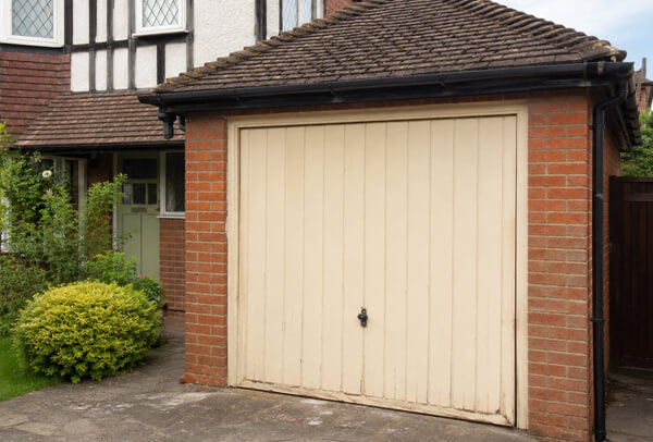 Weathered garage door before preparation in Aylesbury