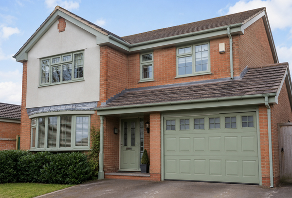 Property exterior in Aylesbury before window frame garage door and roofline painting
