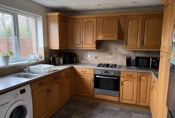 Dated cream kitchen cupboards before painting in Aylesbury