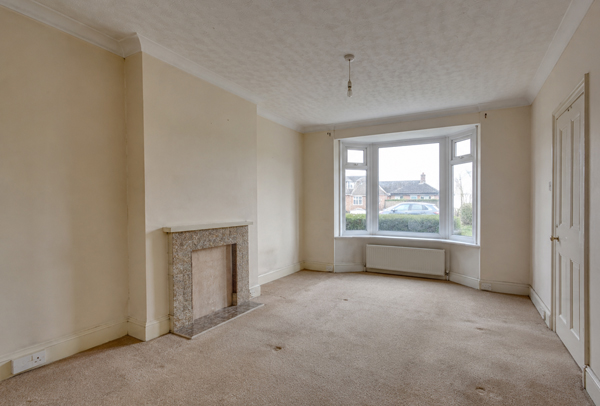 Living room in Ampthill before painting and decorating with dull walls and tired woodwork
