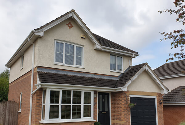 Roofline before repainting in Aylesbury showing tired fascias soffits and guttering